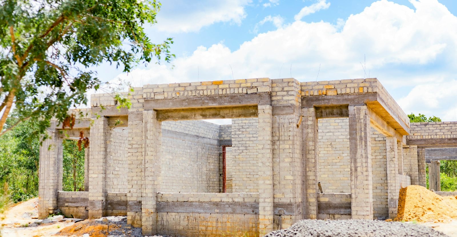 Brick house under construction on a fresh concrete slab