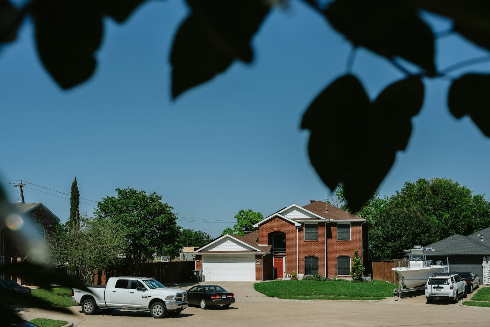 Brick house with cars parked in the driveway