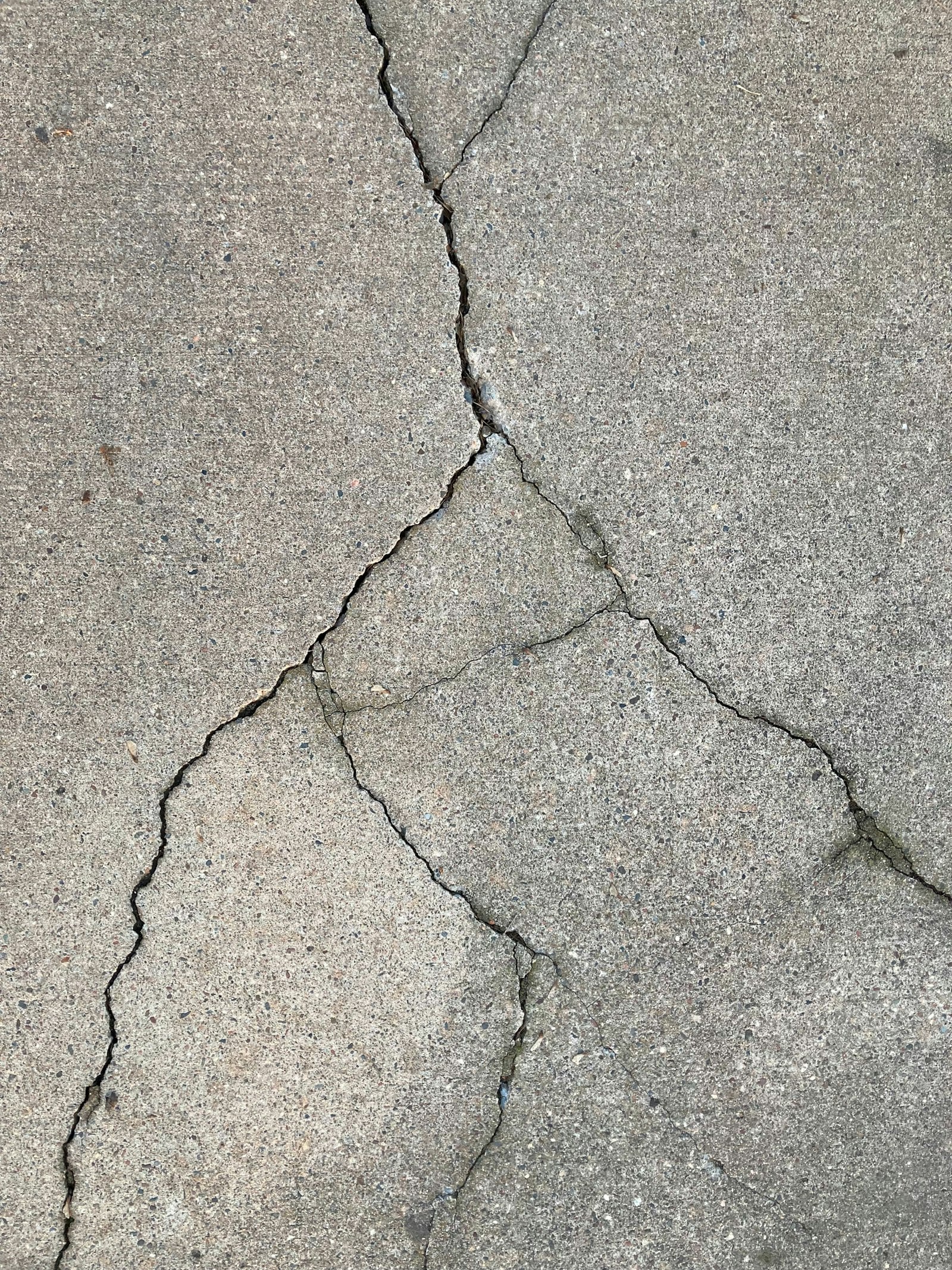 Cracks spreading across a concrete surface